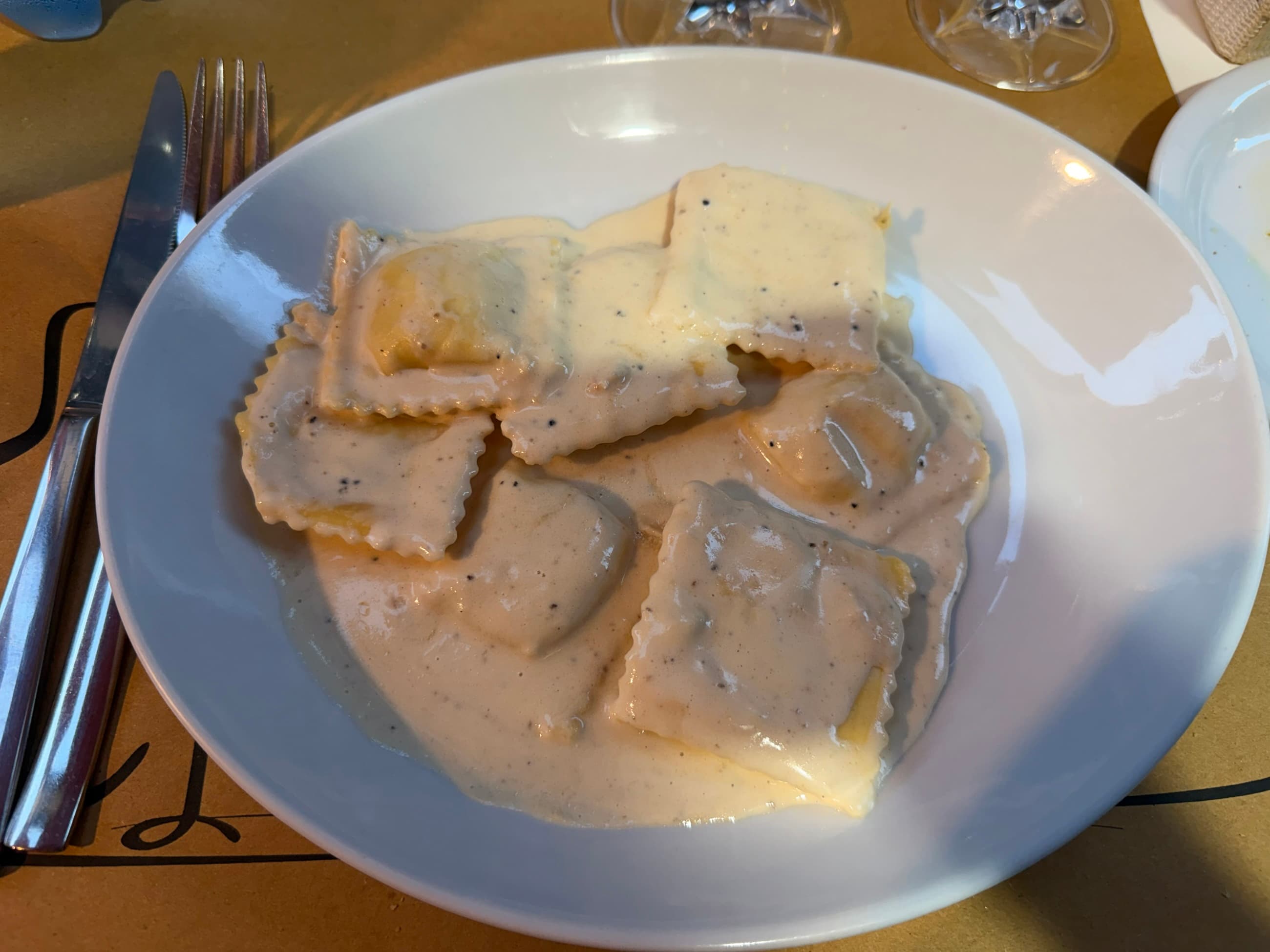 the man brought Aidan his pasta then turned to me and said “come with me”
…?
points me to his wife inside the door who has a wheel of Parmesan, lights a pan of oil on fire, then pours it into the cheese with fresh truffles to make my sauce.
Yum.